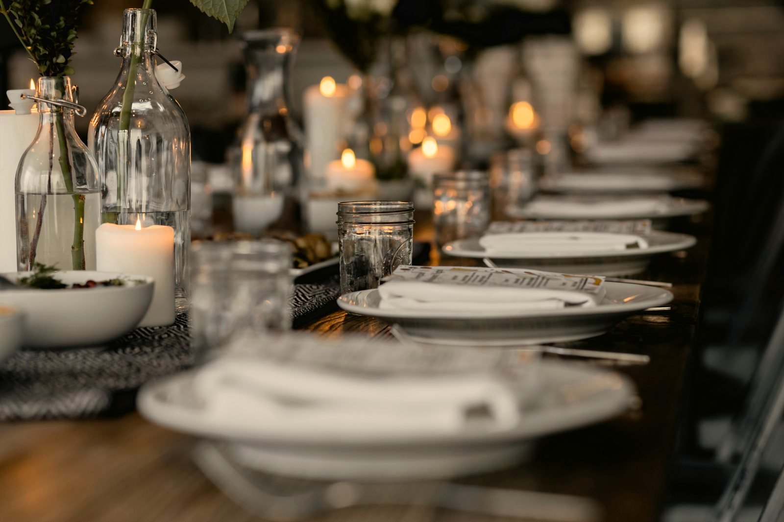 A candlelit dinner table set for guests, no phones in sight